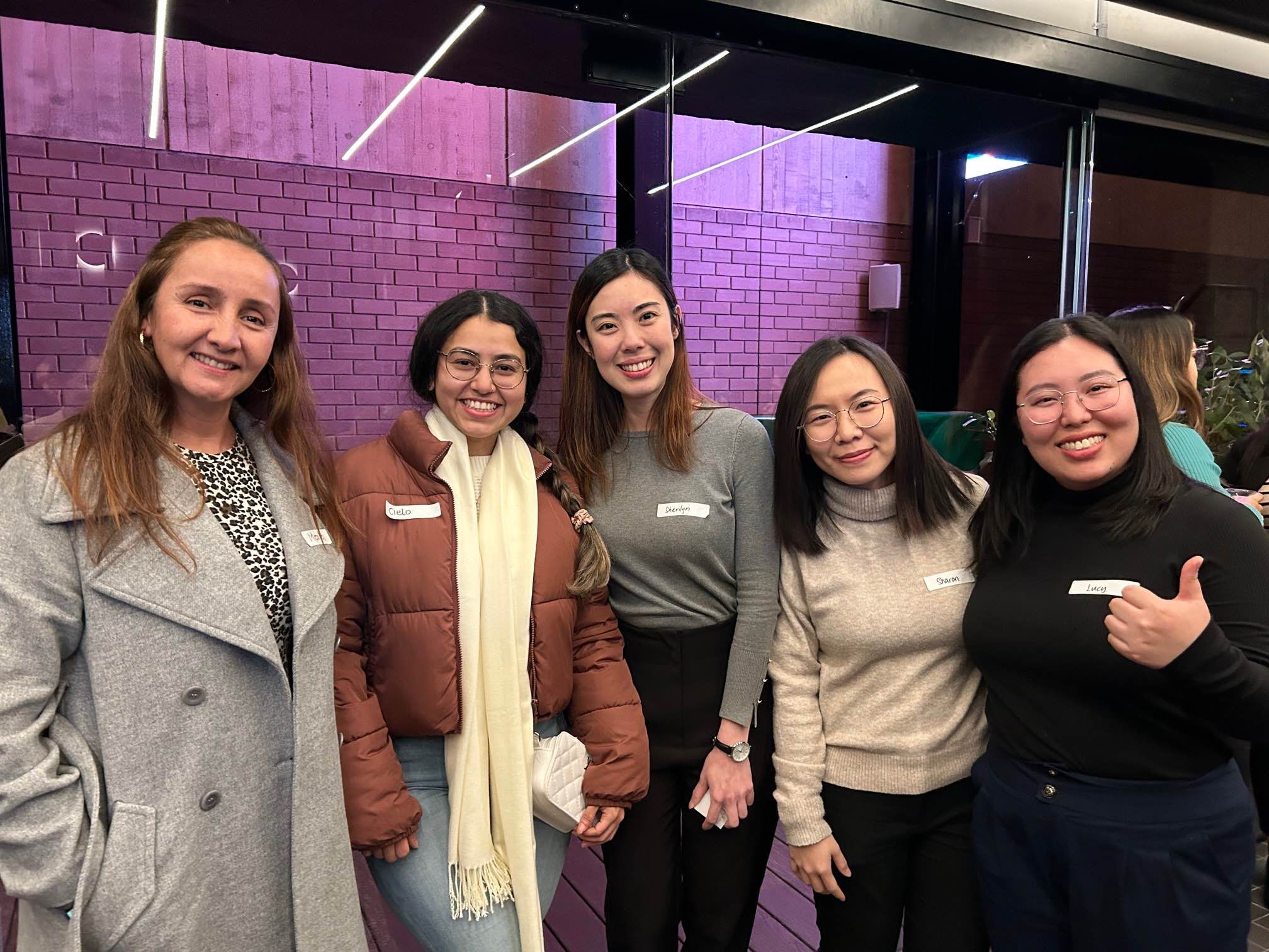 A positive photo of 5 women with brighten smiles
